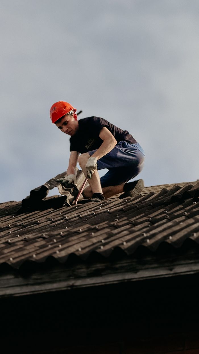 The Art of Drawing Readers In: Your attractive post title goes here A construction worker with a safety helmet is repairing a roof outdoors during the day.